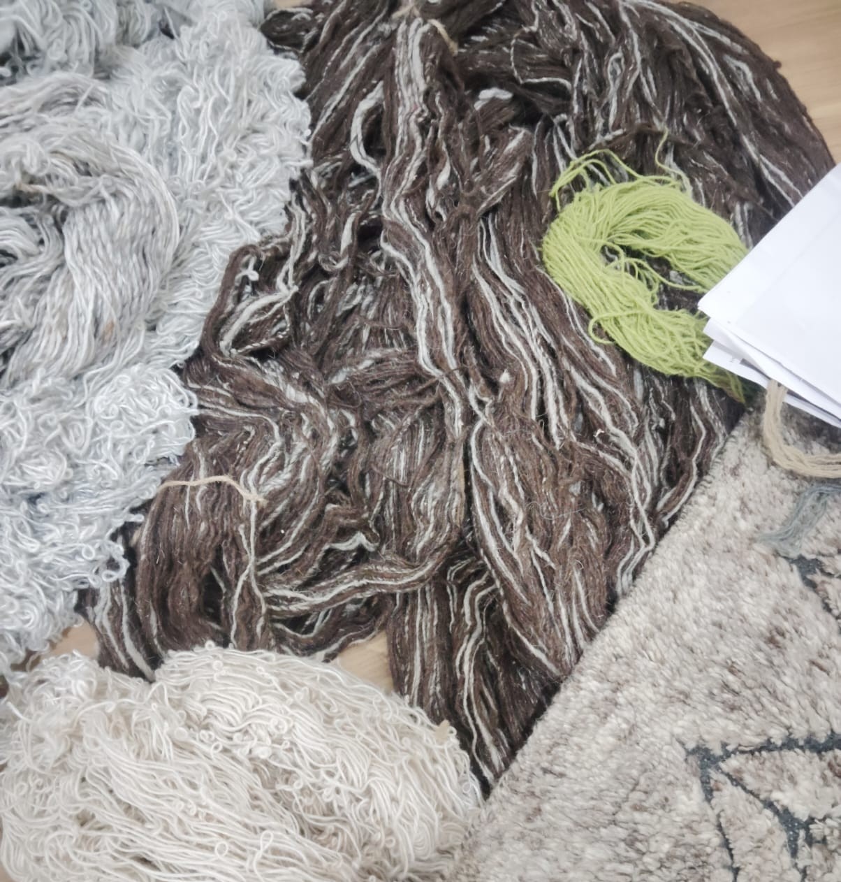 Close up of artisan hand-knotting a rug